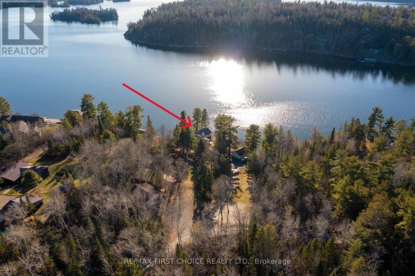 Aerial view of the property near a lake, highlighting its location among wooded areas. - 21 Tinker's Road, Sioux Narrows Nestor Falls