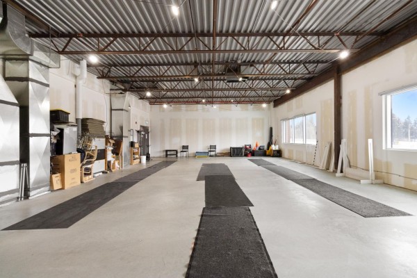 Expansive commercial interior with concrete flooring and unfinished drywall walls. - 210, 450 Ordze Road, Sherwood Park