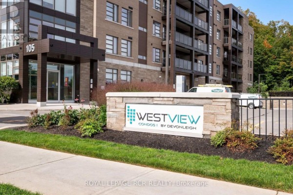 Close-up of the entrance to Westview Condos with stone signage and landscaping. - 210 - 105 Spencer Avenue, Orangeville