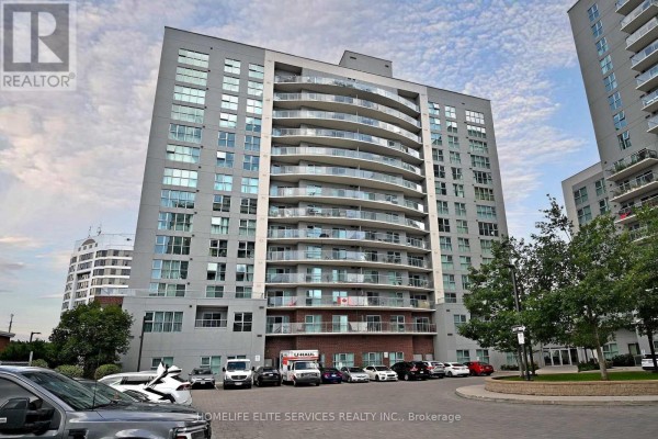 Exterior view of a tall apartment building with many glass balconies and grey siding. - 210 - 2152 Lawrence Avenue E, Toronto