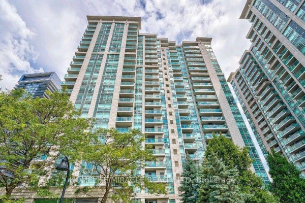 Exterior view of a condo building with trees and surrounding buildings. - 210 - 31 Bales Avenue, Toronto