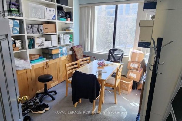 Small meeting room with a table, chairs, and storage shelves - 210 - 712 Davis Drive, Newmarket