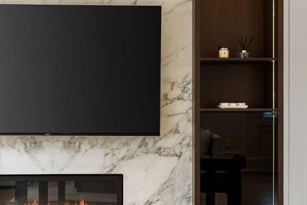 Living room with marble fireplace, TV, and built-in shelving - 210 Horsham Avenue Toronto