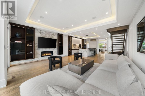 Modern living room with fireplace, open concept kitchen, and sofa - 210 Horsham Avenue Toronto