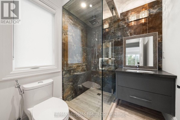 Glass-enclosed shower, modern vanity & toilet - 210 Horsham Avenue Toronto