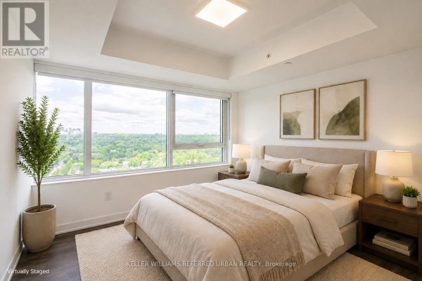 Bedroom with a queen-size bed, large window with green views, and neutral decor. - 2104 - 609 Sherbourne Street, Toronto