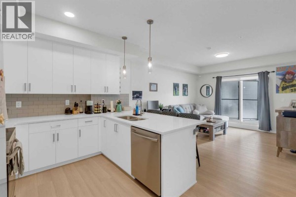 Entrance with a ramp, landscaped area, and glass doors leading inside. - 2106, 33 Carringham Gate Nw, Calgary