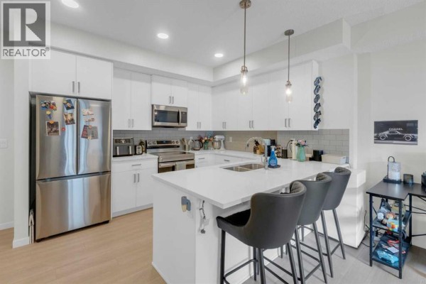 Lobby area with mailboxes, seating, and access to the elevator. - 2106, 33 Carringham Gate Nw, Calgary