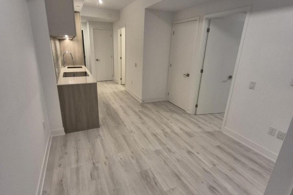 View of an open-concept living area with light wood cabinets and doors. - 2106 - 36 Olive Avenue, Toronto
