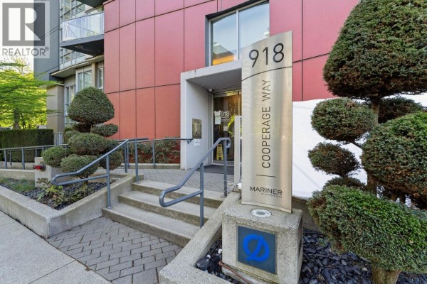 Entrance to 918 Cooperage Way building with signage and manicured topiary bushes. - 2106 918 Cooperage Way, Vancouver