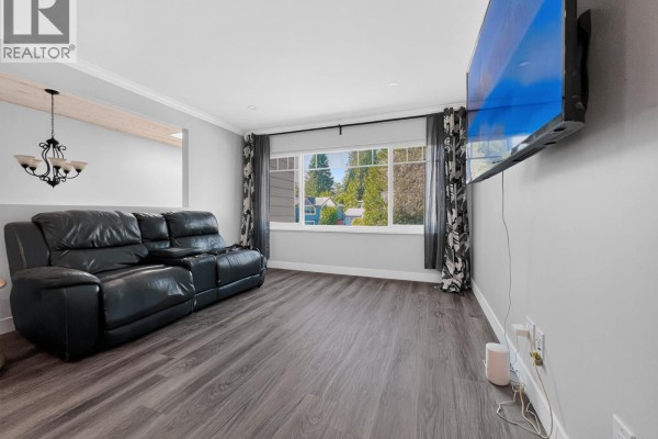 Front exterior of a two-story house with grey siding and a dark brown garage door. - 21066 Glenwood Avenue, Maple Ridge