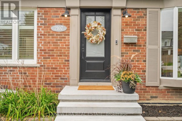 Front entrance with black door, sidelights, and wreath decoration. - 2107 Russett Road, Mississauga