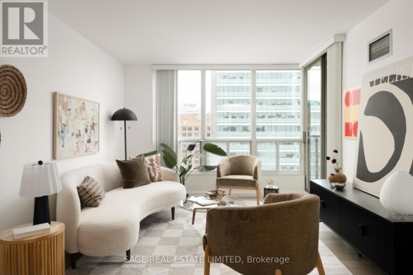 Living room featuring a curved sofa, accent chairs, glass coffee table, and modern art on the walls. - 2109 - 750 Bay Street, Toronto