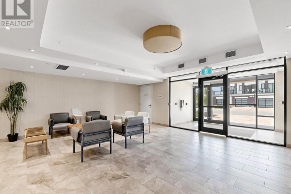 View through lobby glass doors of building exterior and courtyard. - 211 - 1 Climo Lane, Markham