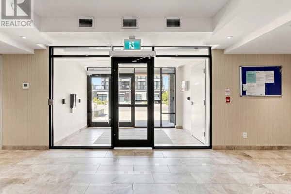 Building lobby with lounge area, coffee table, and view to exterior. - 211 - 1 Climo Lane, Markham