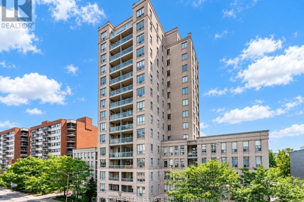 Exterior view of a mid-rise condominium building with balconies and a beige facade. - 211 - 35 Merton Street, Toronto