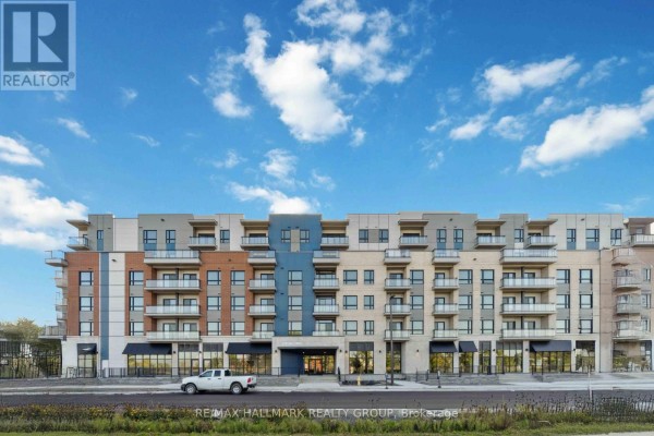 Front facade of a brick and modern apartment building with multiple balconies and ground floor retail spaces. - 211 - 397 Codds Road, Ottawa