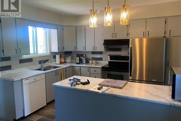 U-shaped kitchen with grey cabinets, stainless steel appliances, and a marble countertop island. - 211 11 Highway, Fauquier Strickland