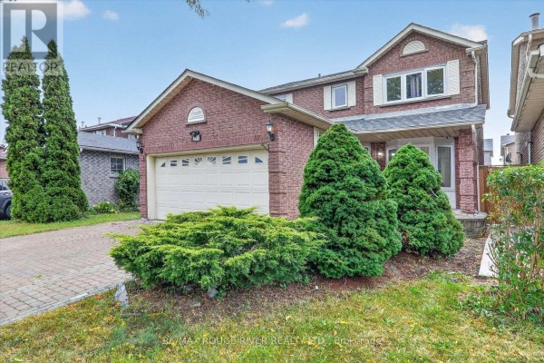 Side view of the brick house's front entrance with manicured bushes and landscaping. - 211 Ponymeadow Terrace, Toronto