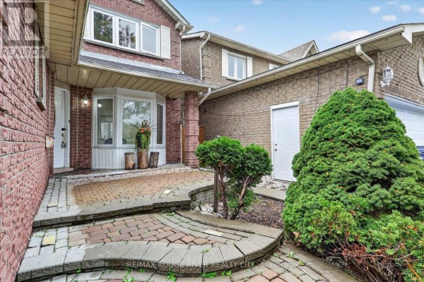 Pathway and steps leading to the front entrance of the brick house. - 211 Ponymeadow Terrace, Toronto