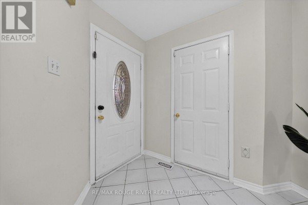 Interior hallway with two white doors and tiled flooring. - 211 Ponymeadow Terrace, Toronto