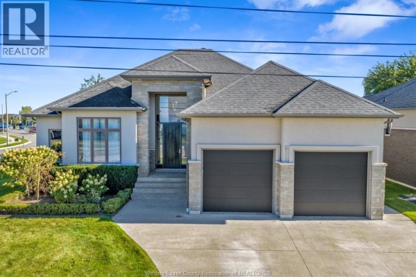 Spacious entryway with tall wooden front door, side windows, white closet, and a built-in bench. - 211 Robson, Leamington