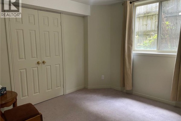 Kitchen area with light wood cabinets, a white stove, refrigerator, and sink. - 2111 Countrystone Place Unit# Lower, Kitchener