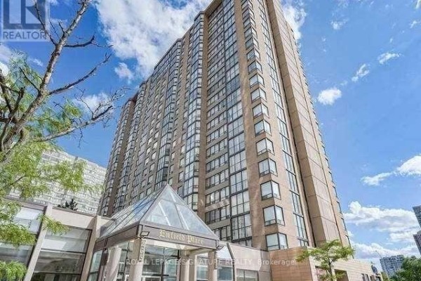 Low angle shot of a modern high-rise apartment building with many windows and a glass entrance canopy. - 2112 - 285 Enfield Place, Mississauga