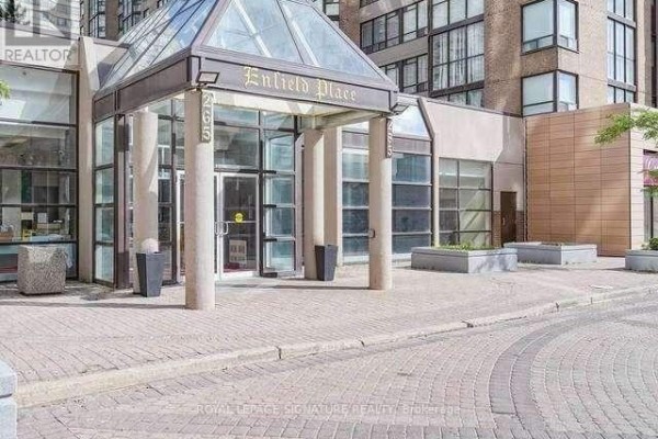 Glass entrance canopy with columns and doors for 285 Enfield Place, set against a brick building. - 2112 - 285 Enfield Place, Mississauga