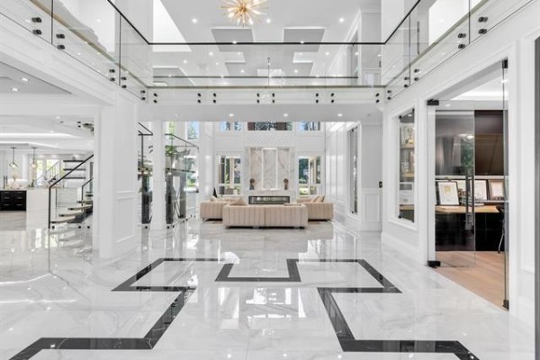 Spacious foyer with plush beige sofas, fireplace, and marble flooring. - 21136 42 Avenue, Langley