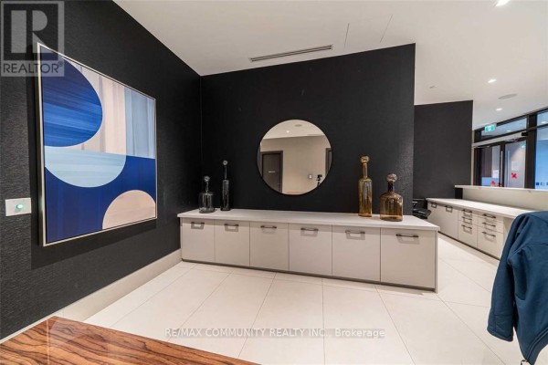Building lobby with dark wallpaper, a long white cabinet, and abstract art. - 2114 - 2550 Simcoe Street N, Oshawa