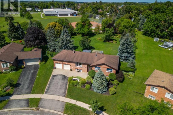 Aerial view of a brick bungalow with a double garage and landscaped front yard. - 2114 Chantler Street, Innisfil