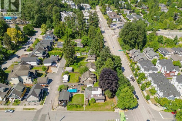 Aerial view of the property lot with several houses, adjacent to a busy multi-lane road and suburban homes. - 2115-2131 St Johns Street, Port Moody