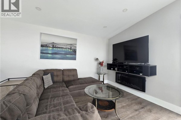 White kitchen cabinets, stainless steel appliances, and marble countertops - 212 2ieme Rue, Shippagan