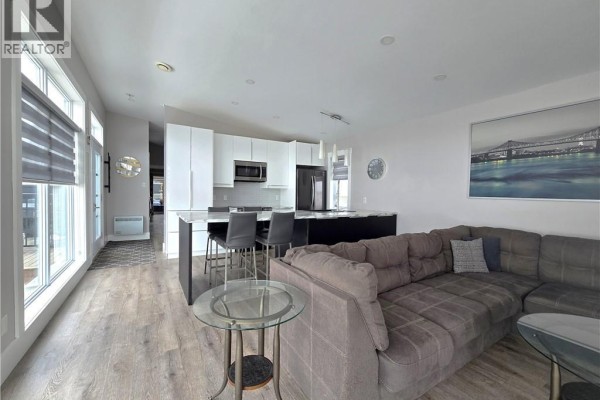 Open living area with large windows, grey blinds, and view of the outdoors - 212 2ieme Rue, Shippagan