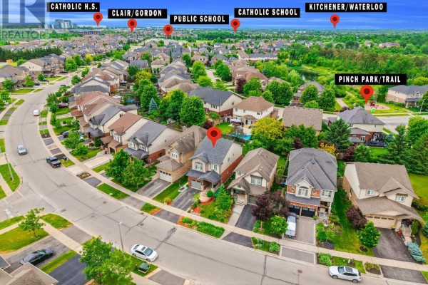 Aerial view of the neighborhood with labels pointing to local amenities like schools and parks. - 212 Goodwin Drive, Guelph