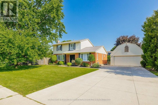 Front view of a residential house with a detached garage and manicured lawn. - 212 Livingston Avenue, Grimsby