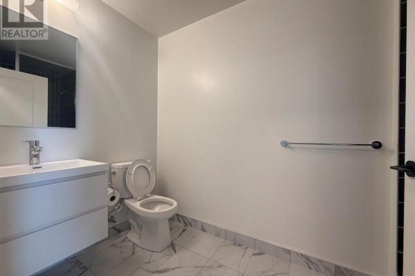 Bathroom featuring black tiled walls, bathtub, and modern vanity - 2120 - 56 Andre De Grasse Street, Markham