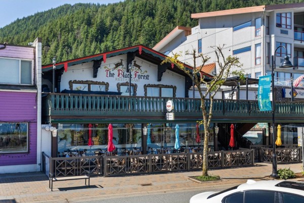 Exterior of The Black Forest Restaurant with outdoor seating and umbrellas. - 212c 160 Esplanade Avenue, Harrison Hot Springs, Harrison Hot Springs