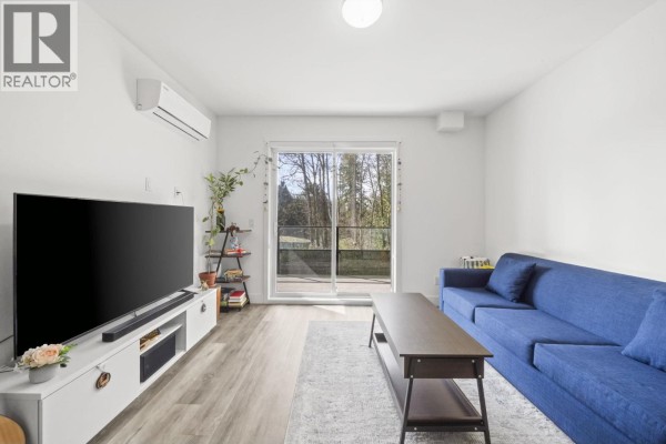 Bedroom with a king bed, a twin bed, a desk, and a window overlooking trees. - 213 12320 222 Street, Maple Ridge