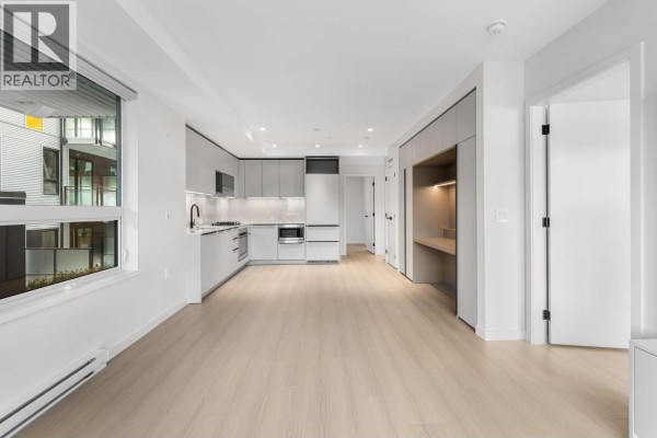 Open concept living area with kitchen, dining, and workspace. - 213 2015 St. Johns Street, Port Moody