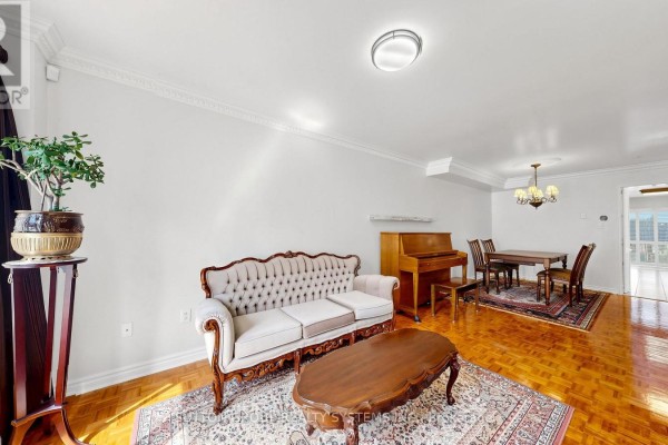 Living room and dining room with a piano, dining table, chairs, and hardwood floors. - 2138 Eglinton Avenue W, Toronto