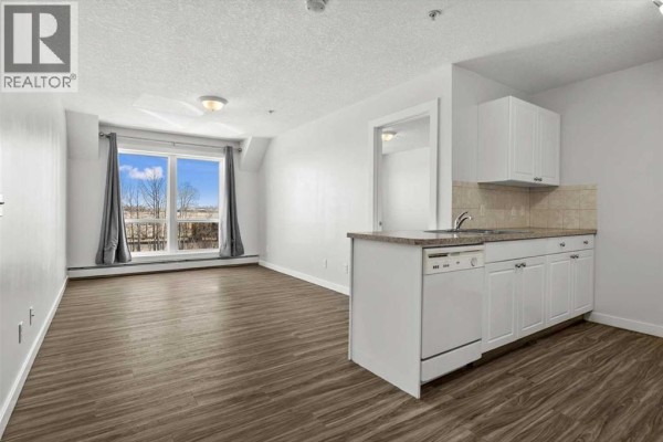 Living room - 214, 1010 Railway Street, Crossfield, AB T0M0M0 Photo 4