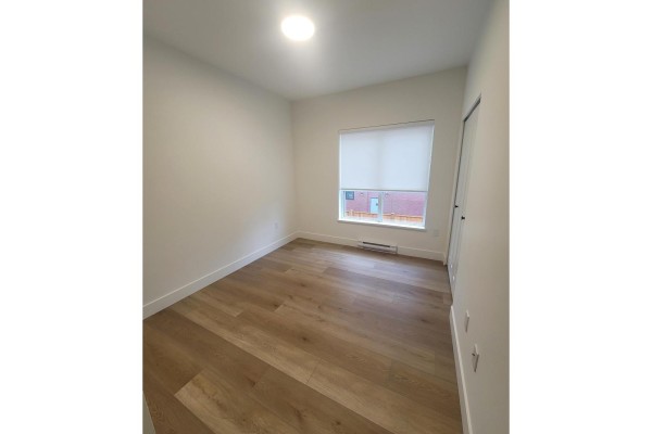 Small room with light wood floors, white walls, and a large window with blinds. - 214 20282 72b Avenue, Langley