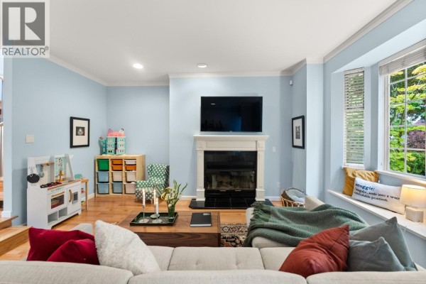 Entryway with light wood floors, white doors, shoe cabinet, and staircase. - 2146 W 14th Avenue, Vancouver