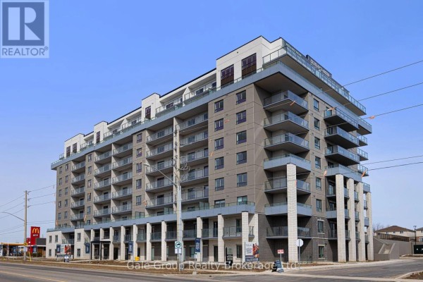 Apartment building exterior showing multiple levels of balconies and grey cladding. - 215 - 425 Watson Parkway N, Guelph