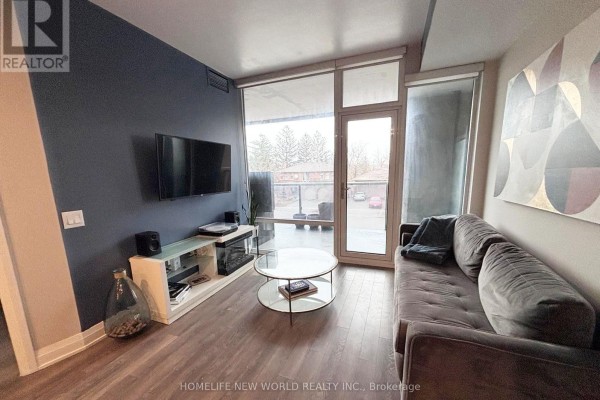 Apartment hallway with light grey walls, dark wood flooring, and a console table. - 215 - 4800 Highway 7, Vaughan