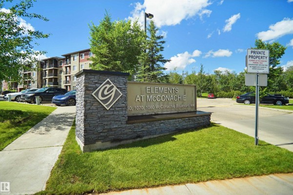 Stone monument sign for Elements at McConachie apartment complex on a grassy lawn. - #215 1070 Mcconachie Blvd Nw, Edmonton