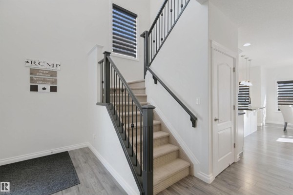Interior view of the staircase, entryway, and doors to other rooms. - 215 Henderson Li, Spruce Grove