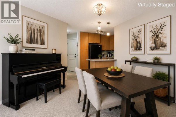 Living and dining area with a black upright piano, black dining table, and metal chairs. - 216, 5115 Richard Road Sw, Calgary